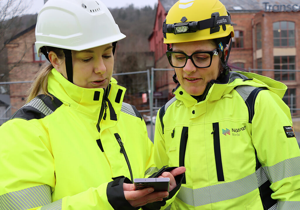 Maria Zetterberg får en visning av hur appen fungerar av en representant från Eningo.